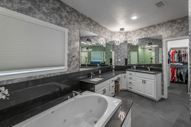 2704 Aurora, Horseshoe Bay, TX 78657 - full bath with a shower stall, vanity, a whirlpool tub, and a walk in closet