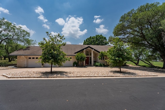 2704 Aurora, Horseshoe Bay, TX 78657 - view of front of house with a tiled roof, driveway, and a garage