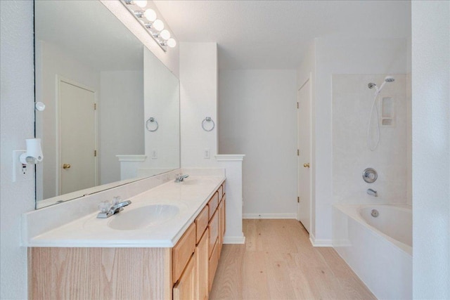 117 Spillway Dr, Kyle, TX 78640 - full bathroom with wood finished floors, double vanity, tub / shower combination, and baseboards