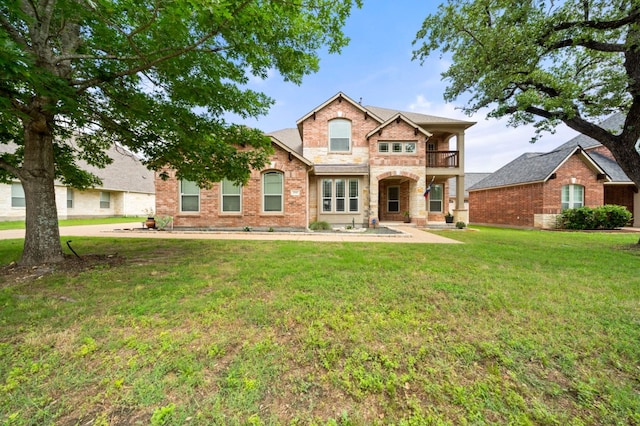 1581 Grassy Field Rd, Austin, TX 78737 - view of front of property with a balcony, a front lawn, and brick siding
