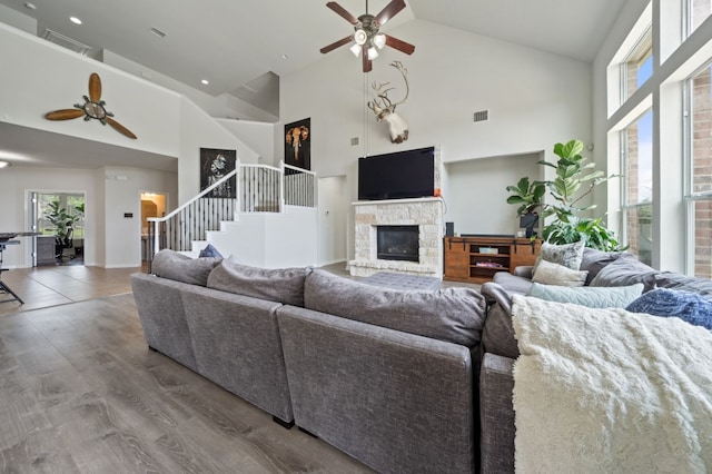 1581 Grassy Field Rd, Austin, TX 78737 - living room with a ceiling fan, high vaulted ceiling, stairs, a fireplace, and wood finished floors