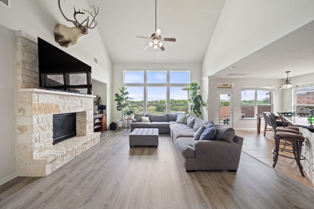 1581 Grassy Field Rd, Austin, TX 78737 - living room with high vaulted ceiling, a ceiling fan, a fireplace, baseboards, and wood finished floors