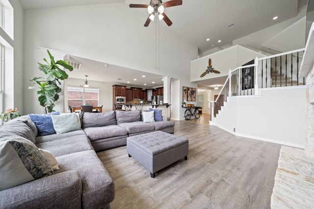 1581 Grassy Field Rd, Austin, TX 78737 - living room with ceiling fan, high vaulted ceiling, stairway, light wood-style floors, and recessed lighting