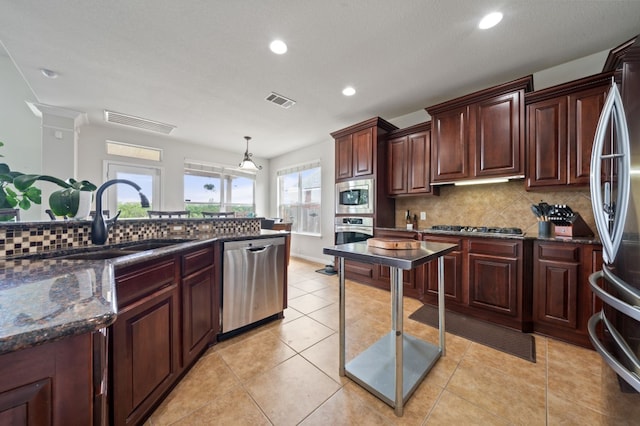1581 Grassy Field Rd, Austin, TX 78737 - kitchen with stainless steel appliances, a sink, tasteful backsplash, recessed lighting, and decorative light fixtures