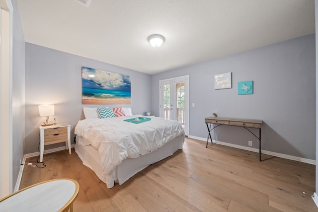 1581 Grassy Field Rd, Austin, TX 78737 - bedroom featuring french doors, light wood-type flooring, access to outside, and baseboards