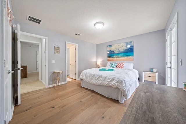 1581 Grassy Field Rd, Austin, TX 78737 - bedroom featuring light wood-type flooring, french doors, and baseboards