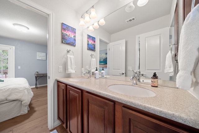 1581 Grassy Field Rd, Austin, TX 78737 - bathroom with ensuite bathroom, double vanity, wood finished floors, and baseboards