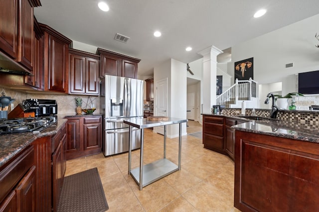 1581 Grassy Field Rd, Austin, TX 78737 - kitchen featuring stainless steel fridge with ice dispenser, black gas stovetop, decorative backsplash, ornate columns, and recessed lighting