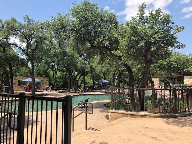 10904 Brazoria Ln Unit 88, Austin, TX 78717 - community pool with a patio area and view of wooded area