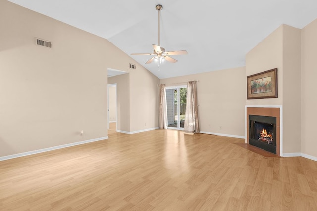 9226 Jollyville Rd Unit 191, Austin, TX 78759 - unfurnished living room featuring a ceiling fan, vaulted ceiling, light wood-style floors, a fireplace with flush hearth, and baseboards