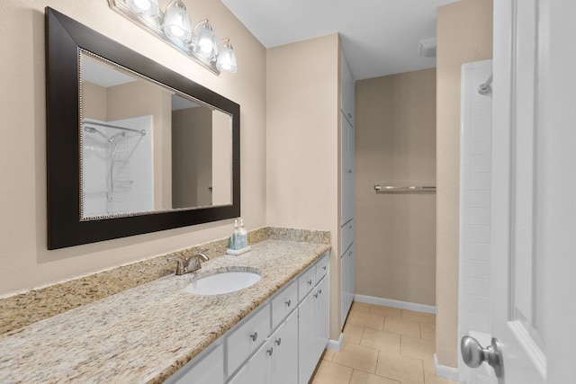 9226 Jollyville Rd Unit 191, Austin, TX 78759 - bathroom featuring vanity, tile patterned floors, baseboards, and a shower