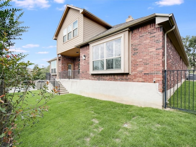 15701 Sayan Cv, Bee Cave, TX 78738 - rear view of house featuring brick siding, a chimney, and stairs