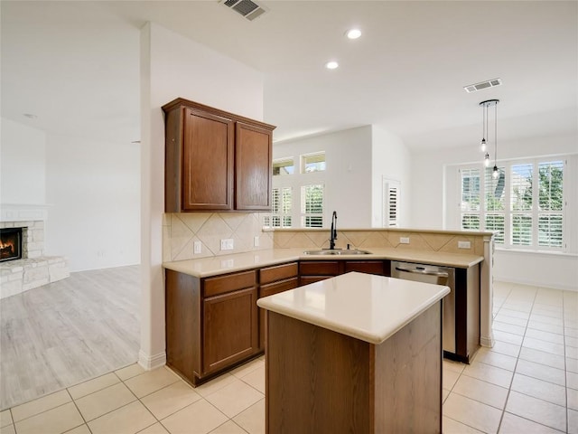 15701 Sayan Cv, Bee Cave, TX 78738 - kitchen featuring a sink, dishwasher, a peninsula, recessed lighting, and light countertops