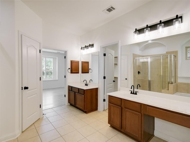 15701 Sayan Cv, Bee Cave, TX 78738 - bathroom with a shower stall, two vanities, and tile patterned floors