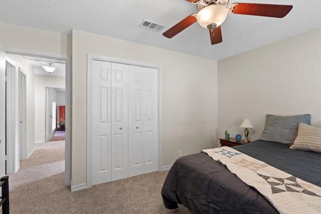 13215 Woodthorpe St, Austin, TX 78729 - carpeted bedroom featuring a closet, a ceiling fan, and a textured ceiling