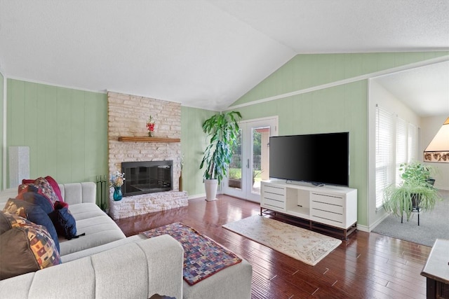13215 Woodthorpe St, Austin, TX 78729 - living room featuring hardwood / wood-style flooring, vaulted ceiling, a large fireplace, and baseboards