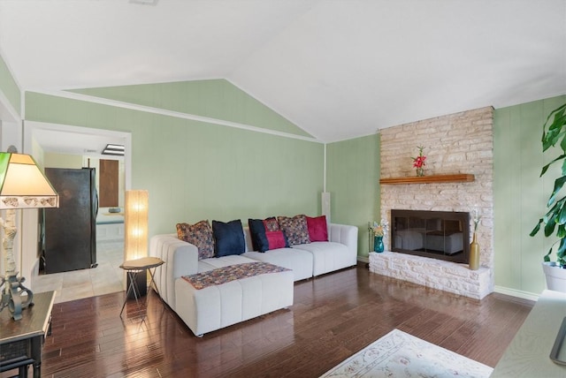 13215 Woodthorpe St, Austin, TX 78729 - living area featuring lofted ceiling, wood finished floors, and a large fireplace