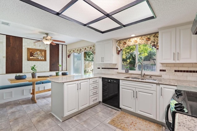 13215 Woodthorpe St, Austin, TX 78729 - kitchen with dishwasher, a sink, range, backsplash, and a textured ceiling