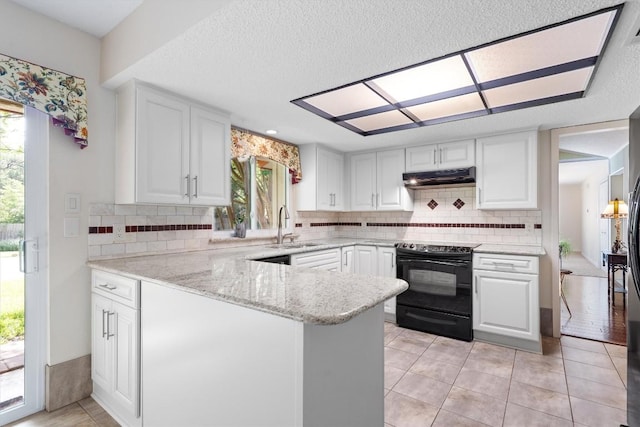 13215 Woodthorpe St, Austin, TX 78729 - kitchen featuring black electric range oven, a sink, healthy amount of natural light, white cabinets, and a textured ceiling