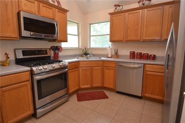 241 Wild Buffalo Dr, Kyle, TX 78640 - kitchen featuring stainless steel appliances, lofted ceiling, light tile patterned flooring, and light countertops