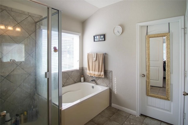 19108 Obed River Dr, Pflugerville, TX 78660 - full bath with a garden tub, a stall shower, tile patterned flooring, vaulted ceiling, and baseboards