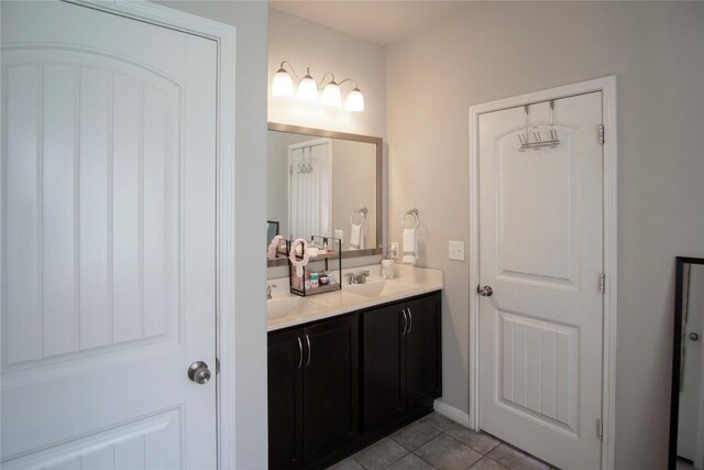 19108 Obed River Dr, Pflugerville, TX 78660 - bathroom with double vanity and tile patterned floors