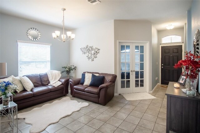 19108 Obed River Dr, Pflugerville, TX 78660 - living room featuring a chandelier, light tile patterned floors, and french doors