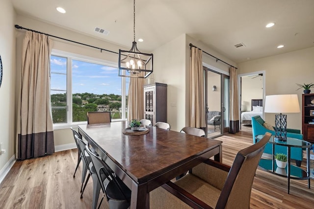 416 Marina Village Cv Unit 416, Austin, TX 78734 - dining room featuring light wood-style flooring, a chandelier, recessed lighting, and baseboards