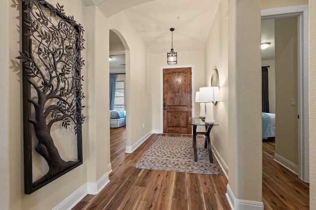416 Marina Village Cv Unit 416, Austin, TX 78734 - entryway with dark wood-style floors, arched walkways, and baseboards