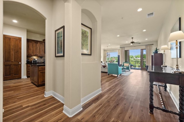 416 Marina Village Cv Unit 416, Austin, TX 78734 - corridor featuring arched walkways, wood finished floors, baseboards, and recessed lighting