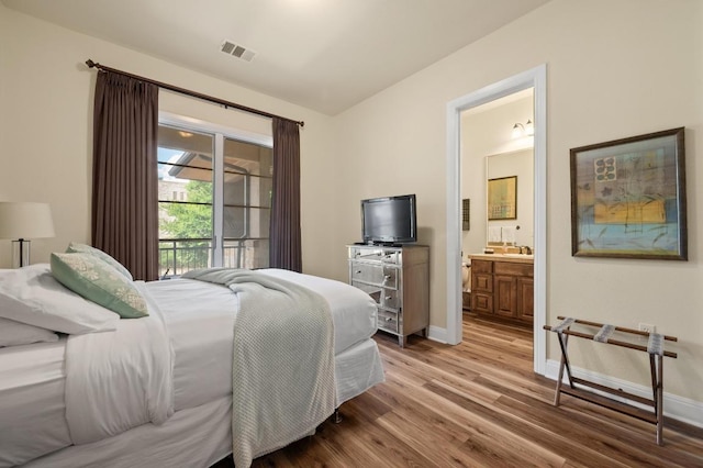 416 Marina Village Cv Unit 416, Austin, TX 78734 - bedroom featuring light wood-style flooring, baseboards, and ensuite bath