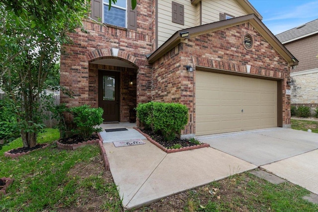 6729 Sunderland Trl, Austin, TX 78747 - doorway to property featuring brick siding, driveway, and an attached garage