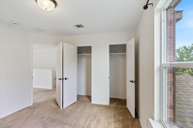 6729 Sunderland Trl, Austin, TX 78747 - unfurnished bedroom featuring carpet floors, two closets, and baseboards