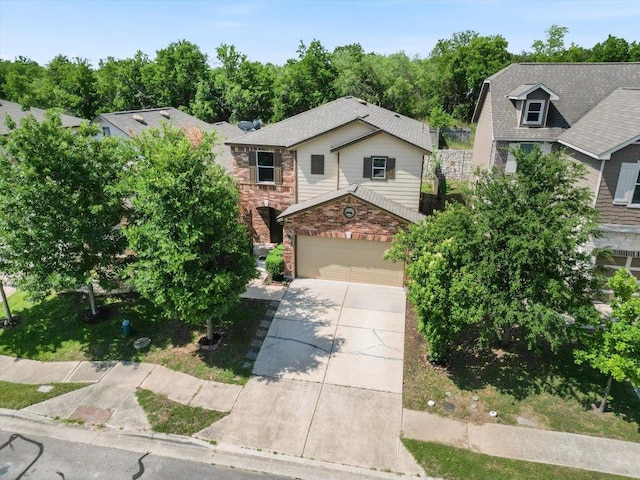 6729 Sunderland Trl, Austin, TX 78747 - view of front facade with concrete driveway, a garage, and stone siding