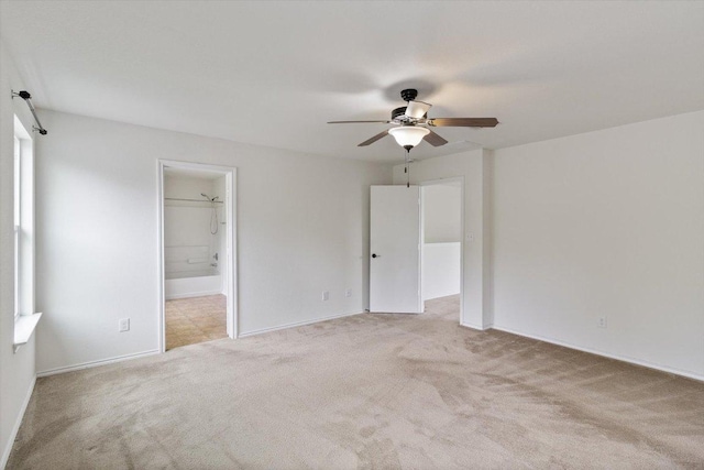 6729 Sunderland Trl, Austin, TX 78747 - unfurnished bedroom with light colored carpet, connected bathroom, baseboards, and a ceiling fan