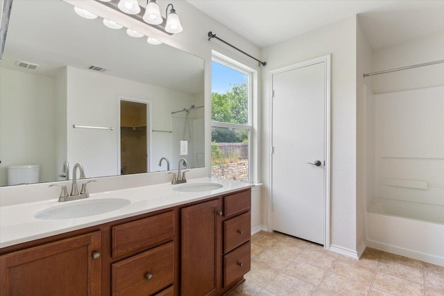 6729 Sunderland Trl, Austin, TX 78747 - full bath with double vanity, shower / washtub combination, toilet, baseboards, and a closet