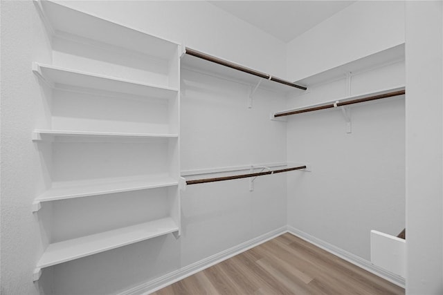 14125 Fallsprings Way, Manor, TX 78653 - spacious closet featuring wood finished floors