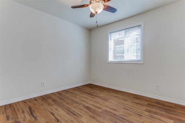 2401 Manor Rd Unit 113, Austin, TX 78722 - spare room featuring wood finished floors, a ceiling fan, and baseboards