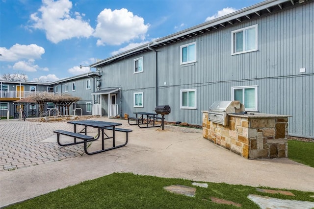 2401 Manor Rd Unit 113, Austin, TX 78722 - back of property with exterior kitchen and a patio