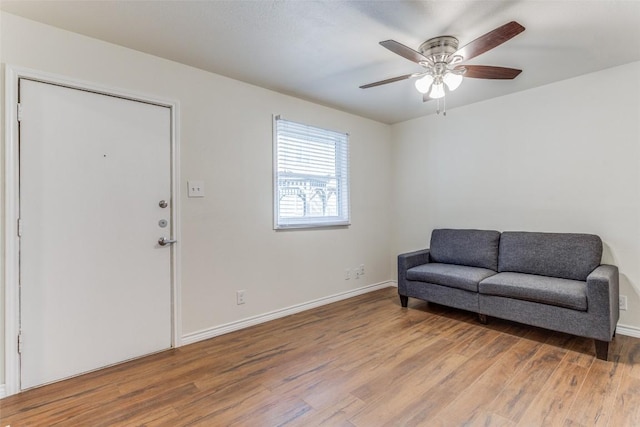 2401 Manor Rd Unit 113, Austin, TX 78722 - sitting room featuring wood finished floors, ceiling fan, and baseboards