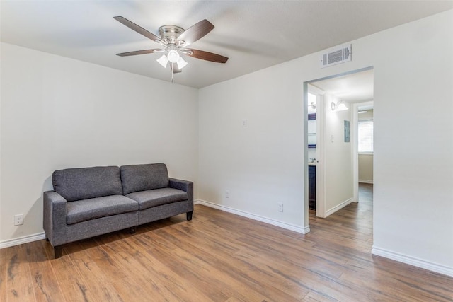 2401 Manor Rd Unit 113, Austin, TX 78722 - sitting room with a ceiling fan, wood finished floors, and baseboards