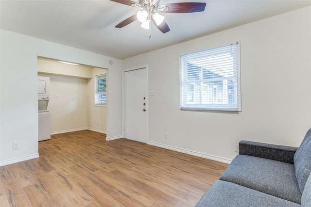 2401 Manor Rd Unit 113, Austin, TX 78722 - living area with light wood-type flooring, baseboards, and ceiling fan