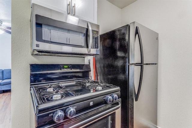 2401 Manor Rd Unit 113, Austin, TX 78722 - kitchen with stainless steel microwave and range with gas cooktop