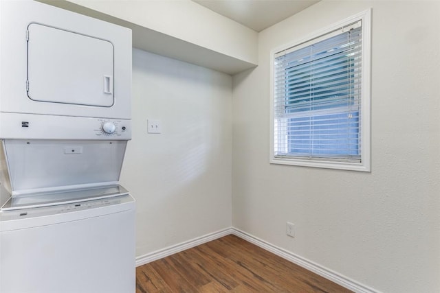2401 Manor Rd Unit 113, Austin, TX 78722 - laundry area with stacked washer / drying machine, dark wood-style flooring, and baseboards