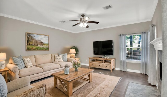 3504 Ashmere Loop SE, Round Rock, TX 78681 - living area with ceiling fan, a fireplace, crown molding, and wood finished floors