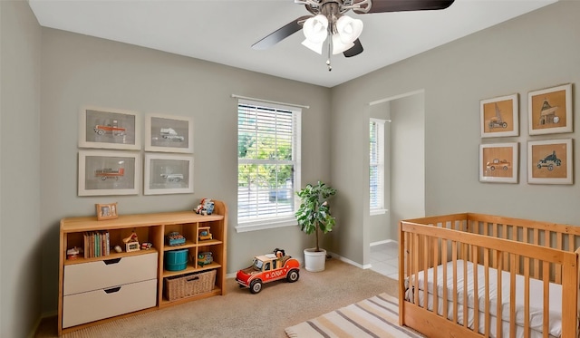 3504 Ashmere Loop SE, Round Rock, TX 78681 - carpeted bedroom featuring a crib and ceiling fan
