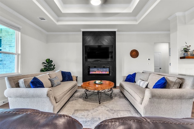 222 Overlook Trl, Copperas Cove, TX 76522 - living area featuring wood finished floors, a fireplace, a raised ceiling, and crown molding