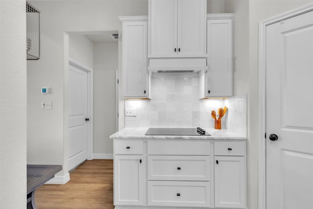 222 Overlook Trl, Copperas Cove, TX 76522 - kitchen featuring black electric cooktop, white cabinetry, tasteful backsplash, and light countertops
