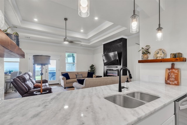 222 Overlook Trl, Copperas Cove, TX 76522 - kitchen with a sink, light stone countertops, stainless steel dishwasher, open floor plan, and white cabinetry
