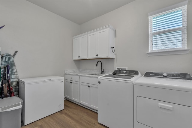 222 Overlook Trl, Copperas Cove, TX 76522 - washroom featuring washing machine and clothes dryer, cabinet space, and wood finished floors